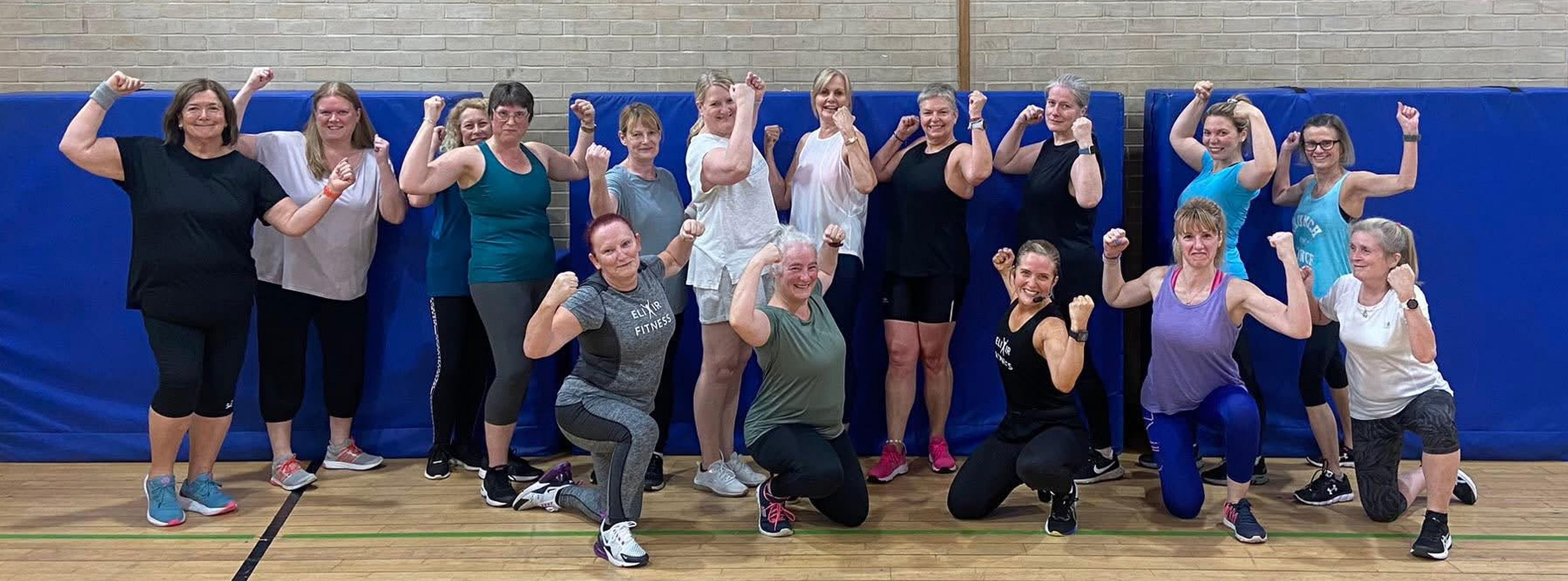 Elixir Fitness members smiling together after a group class